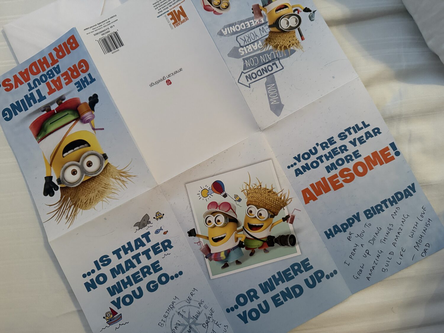 The Minions birthday card fully unfolded flat, showing the front panel, signpost artwork and the inside message.